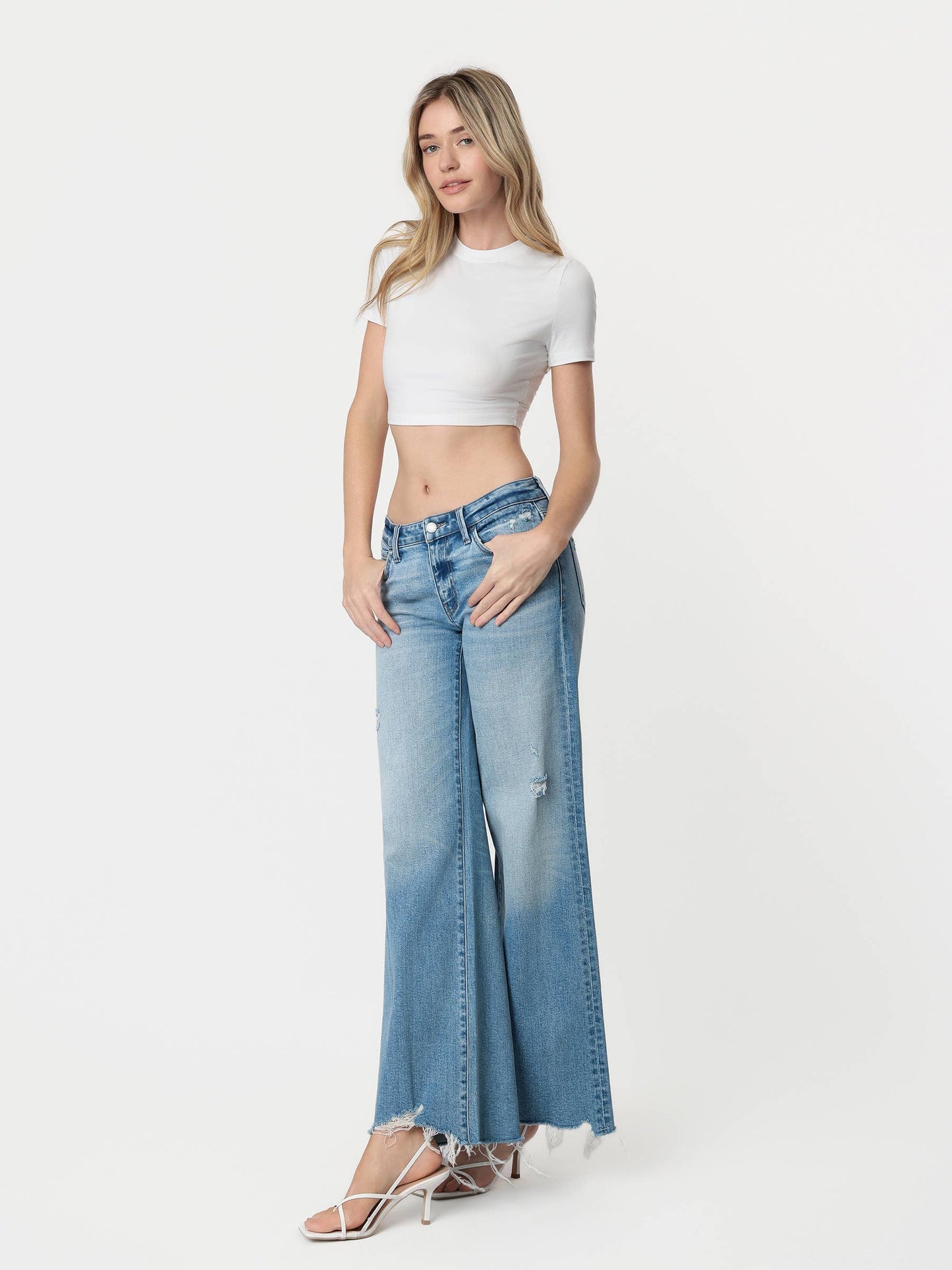 LOW RISE TINTED MEDIUM WASH WIDE FLARE JEANS
