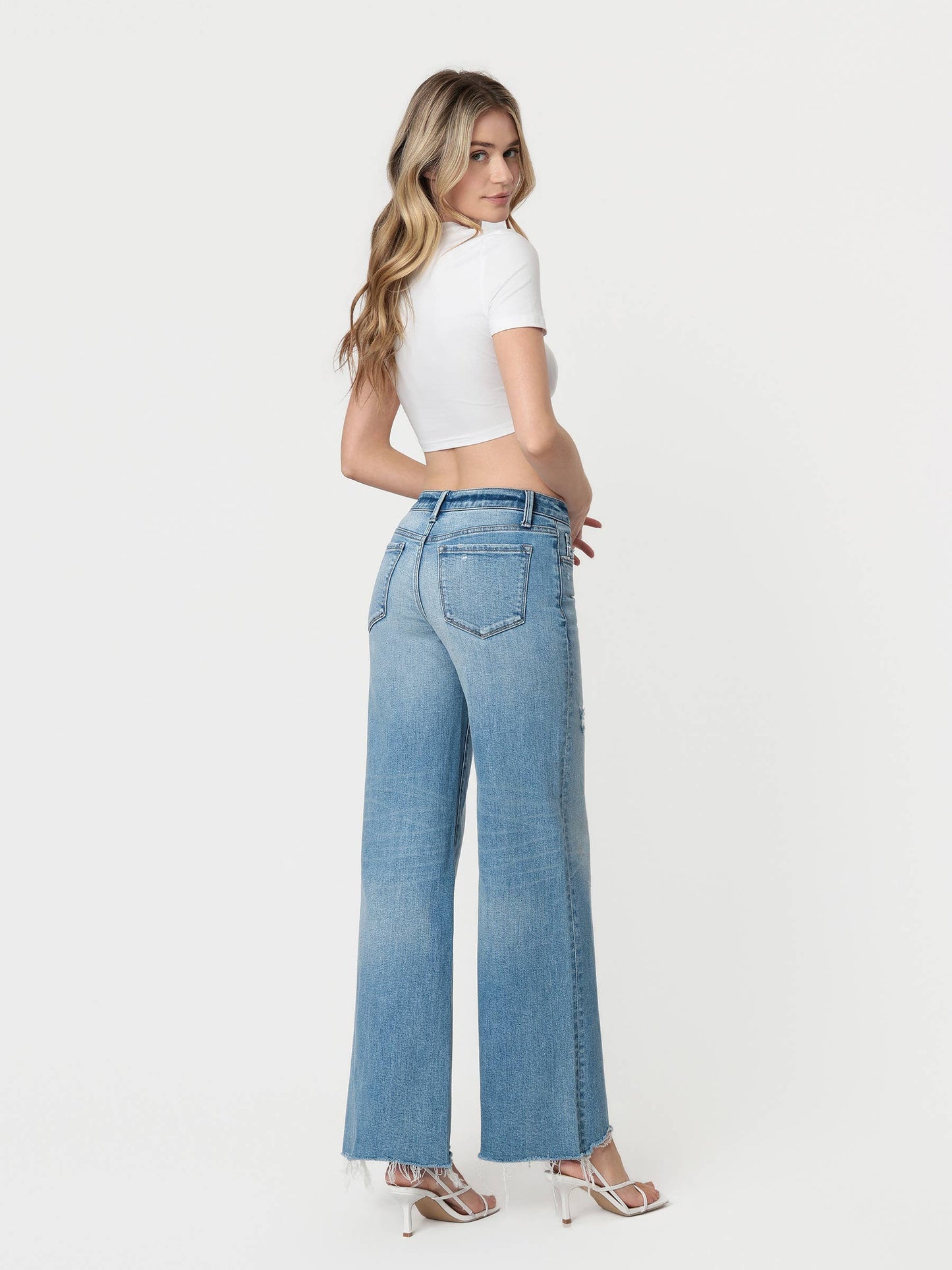 LOW RISE TINTED MEDIUM WASH WIDE FLARE JEANS